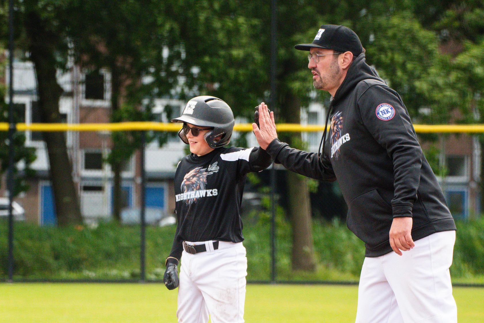 Little League baseball team together on the field