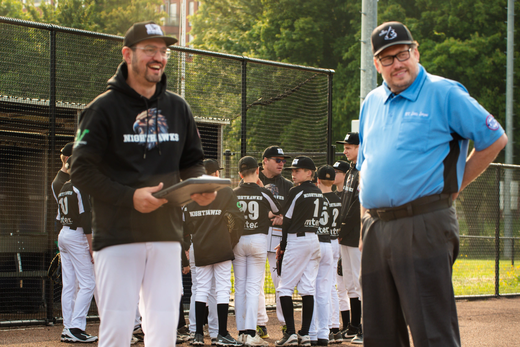 Little League team practicing on a Texas diamond at sunset