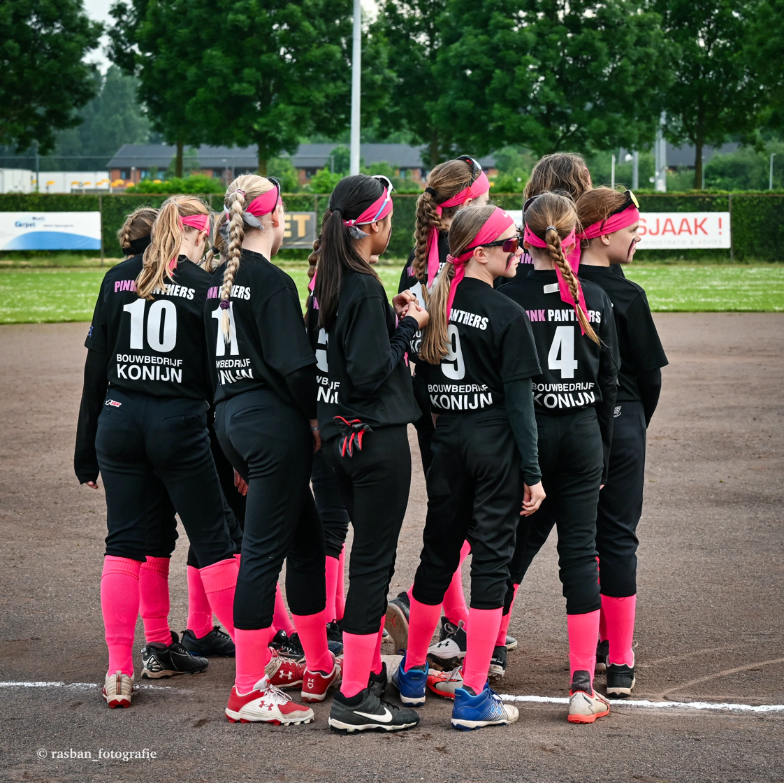 Diverse Little League team celebrating together on a California field